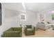 Cozy living room with modern furnishings, including green chairs, and natural light at 1227 Epworth Sw St, Atlanta, GA 30310