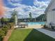 Beautiful community pool view with seating, lush plants, and well manicured lawn at 918 Keystone Dr, Woodstock, GA 30188