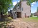 Spacious backyard with a deck, mature trees, and a well-manicured lawn at 2138 Mill Garden Run, Buford, GA 30519