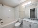 Bright bathroom features a shower-tub combo and a marble-topped vanity sink at 2138 Mill Garden Run, Buford, GA 30519