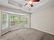 Primary bedroom featuring a ceiling fan and bay window with a view of the backyard at 2138 Mill Garden Run, Buford, GA 30519