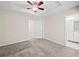 Spacious bedroom featuring plush carpeting and a stylish ceiling fan for added comfort at 2138 Mill Garden Run, Buford, GA 30519