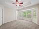 Primary bedroom featuring a ceiling fan and bay window with a view of the backyard at 2138 Mill Garden Run, Buford, GA 30519