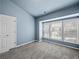 This bedroom has blue walls, gray carpet and large windows at 2138 Mill Garden Run, Buford, GA 30519