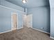The room features a neutral carpet and walls with light blue trim at 2138 Mill Garden Run, Buford, GA 30519