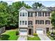 Charming townhome with brick and siding exterior, featuring a garage and well-maintained landscaping at 2138 Mill Garden Run, Buford, GA 30519