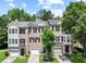 Charming brick townhomes with well-maintained landscaping and attached garages at 2138 Mill Garden Run, Buford, GA 30519