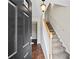 Inviting foyer with tile flooring, staircase with wooden handrail, and neutral paint, leading to other rooms at 2138 Mill Garden Run, Buford, GA 30519