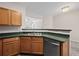 Open kitchen with wooden cabinets, stainless steel appliances, and green countertops at 2138 Mill Garden Run, Buford, GA 30519