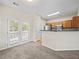 Open kitchen area with stainless steel appliances and access to an outdoor deck at 2138 Mill Garden Run, Buford, GA 30519