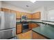 Well-equipped kitchen featuring stainless steel appliances and green countertops at 2138 Mill Garden Run, Buford, GA 30519