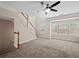 Spacious living area with a staircase, large windows, and modern ceiling fan at 2138 Mill Garden Run, Buford, GA 30519