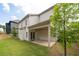 Well-maintained backyard featuring a covered patio and manicured lawn with retaining wall at 2428 Mills Bnd, Decatur, GA 30034