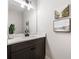 Modern bathroom with dark cabinets, white quartz countertops, and decorative wall art at 2428 Mills Bnd, Decatur, GA 30034