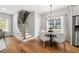 Bright dining area with hardwood floors, modern chandelier, and large windows with natural light at 2428 Mills Bnd, Decatur, GA 30034