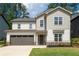 Charming two-story home features a two-car garage and beautifully landscaped front yard at 2428 Mills Bnd, Decatur, GA 30034