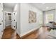 Hallway with hardwood floors leading to bathroom and living room with sliding glass doors at 2428 Mills Bnd, Decatur, GA 30034