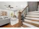 Bright living room with fireplace, French doors, and staircase with wood treads and iron railing at 2428 Mills Bnd, Decatur, GA 30034