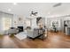 Spacious living room featuring fireplace, large windows, hardwood flooring and adjoining dining area at 2428 Mills Bnd, Decatur, GA 30034