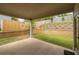 Covered patio overlooking a tiered backyard with grass and a retaining wall with fence at 2428 Mills Bnd, Decatur, GA 30034