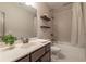 Bathroom with floating shelves, a sink, and a shower-tub combo with neutral colors at 3825 Valleyway Rd, Cumming, GA 30040