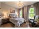 Cozy bedroom offers hardwood floors, natural light, and stylish furnishings at 3825 Valleyway Rd, Cumming, GA 30040