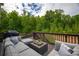 Relaxing outdoor deck area with comfortable seating and a beautiful wooded view at 3825 Valleyway Rd, Cumming, GA 30040