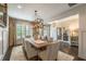 Elegant dining room featuring a large table, stylish chandelier, and ample natural light at 3825 Valleyway Rd, Cumming, GA 30040