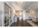 Inviting foyer with hardwood floors, elegant lighting, glass French doors, and decorative wainscoting at 3825 Valleyway Rd, Cumming, GA 30040