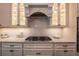 Kitchen features granite counters, a modern gas range, glass cabinets, and a decorative tile backsplash at 3825 Valleyway Rd, Cumming, GA 30040