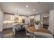 Well-lit kitchen boasts stainless appliances, granite counters, seating at the island, and a breakfast nook at 3825 Valleyway Rd, Cumming, GA 30040