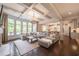 Spacious living room with coffered ceilings, fireplace, ample seating, and view into the kitchen at 3825 Valleyway Rd, Cumming, GA 30040