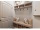 Well-organized mudroom features a storage bench, hooks, and overhead storage for shoes and coats at 3825 Valleyway Rd, Cumming, GA 30040