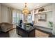 Home office with a large desk, custom built-ins, modern lighting, and plantation shutters at 3825 Valleyway Rd, Cumming, GA 30040