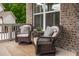 Cozy front porch features comfortable seating and brick accents at 3825 Valleyway Rd, Cumming, GA 30040