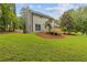 Well-manicured backyard with a wooden deck, providing an inviting space for outdoor living and entertaining at 4657 Lou Ivy Rd, Peachtree Corners, GA 30096