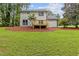 Backyard featuring a well-maintained lawn and a wooden deck, ideal for relaxation and recreation at 4657 Lou Ivy Rd, Peachtree Corners, GA 30096