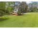 Expansive backyard with lush lawn and a wooden deck, perfect for outdoor activities and entertaining at 4657 Lou Ivy Rd, Peachtree Corners, GA 30096