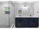 Bathroom featuring double vanity with marble countertops, glass enclosed shower with niche at 4657 Lou Ivy Rd, Peachtree Corners, GA 30096