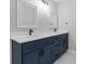 Dual sink bathroom featuring a quartz countertop, contemporary fixtures and navy blue cabinetry at 4657 Lou Ivy Rd, Peachtree Corners, GA 30096
