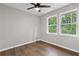 Bedroom with hard surface flooring, neutral walls and double windows looking out to trees at 4657 Lou Ivy Rd, Peachtree Corners, GA 30096