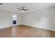 Large bedroom with wood-look flooring and a view to a bathroom with blue cabinetry at 4657 Lou Ivy Rd, Peachtree Corners, GA 30096