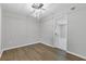 Bright dining room featuring wood floors, modern lighting fixture and view to a kitchen space at 4657 Lou Ivy Rd, Peachtree Corners, GA 30096
