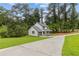 This two-story home features a long driveway and manicured lawns, set amongst mature shade trees at 4657 Lou Ivy Rd, Peachtree Corners, GA 30096