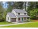 Inviting two-story home boasts a fresh exterior, complemented by a well-manicured lawn and lush trees at 4657 Lou Ivy Rd, Peachtree Corners, GA 30096