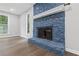 Close up of a blue painted stone fireplace with a white mantle and hearth at 4657 Lou Ivy Rd, Peachtree Corners, GA 30096
