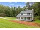 Inviting home with a freshly landscaped front yard, a bright blue door, and a charming front porch at 4657 Lou Ivy Rd, Peachtree Corners, GA 30096