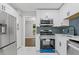 Modern kitchen featuring stainless steel appliances and plenty of countertop space at 4657 Lou Ivy Rd, Peachtree Corners, GA 30096