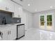 Kitchen featuring stainless steel dishwasher and stylish double doors to outside deck at 4657 Lou Ivy Rd, Peachtree Corners, GA 30096