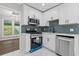 Bright kitchen boasts stainless appliances, white cabinets, and modern finishes at 4657 Lou Ivy Rd, Peachtree Corners, GA 30096